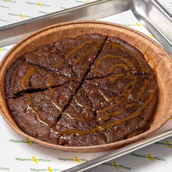 A Magoo's California Pizza brownie dessert, cut into slices and drizzled with caramel sauce.