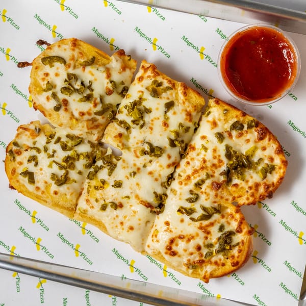 Magoo's California Pizza jalapeño cheese breadsticks with a side of marinara sauce.
