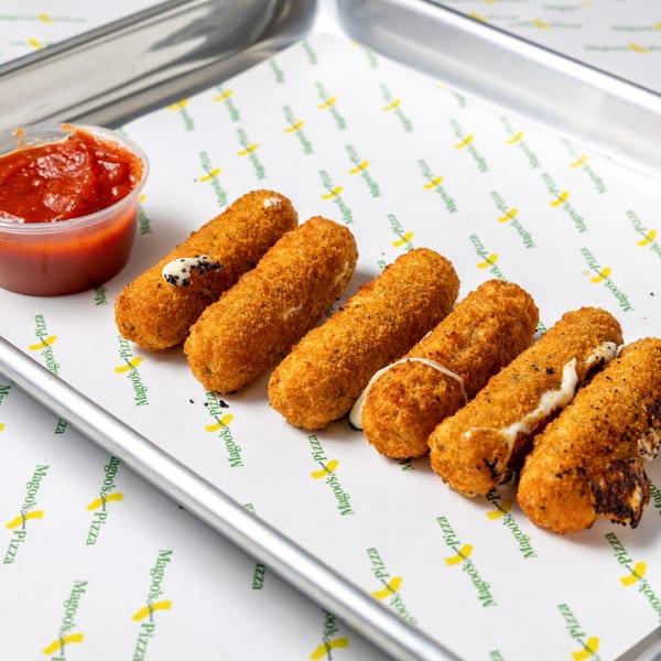 Golden-brown mozzarella sticks with melted cheese and a side of red marinara sauce on a Magoo's Pizza tray.
