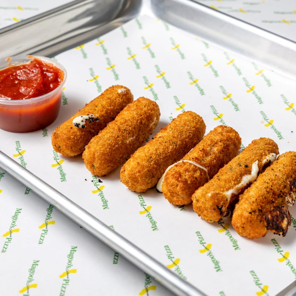 Golden-brown mozzarella sticks with melted cheese and a side of red marinara sauce on a Magoo's Pizza tray.